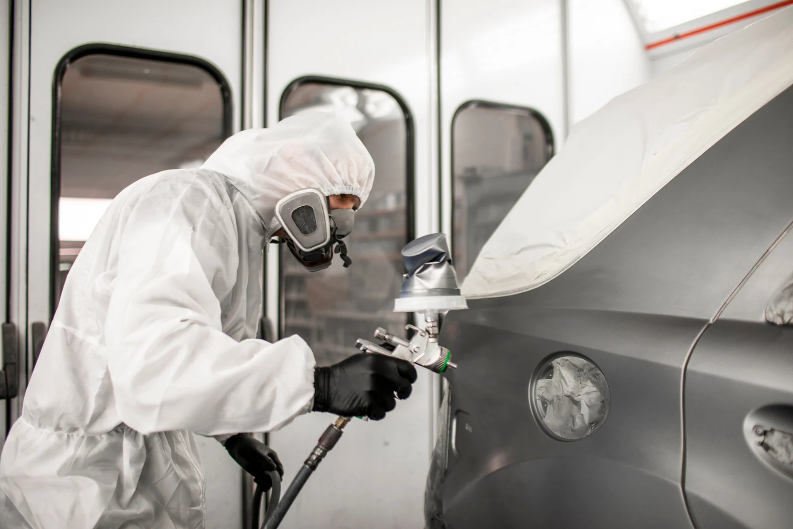 Vehicle inside a paint spray booth at bodyshop