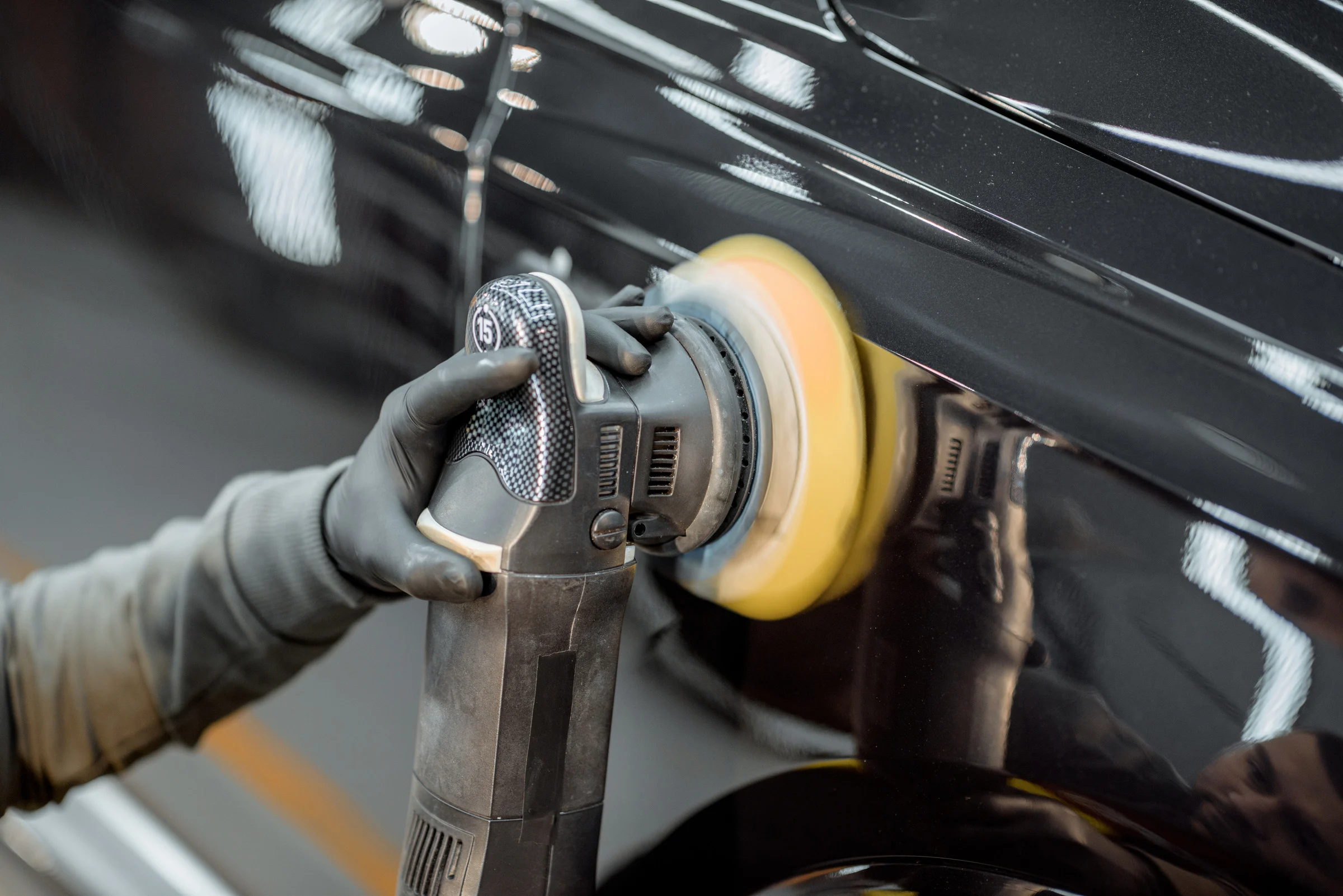 Machine polishing service being performed on a vehicle